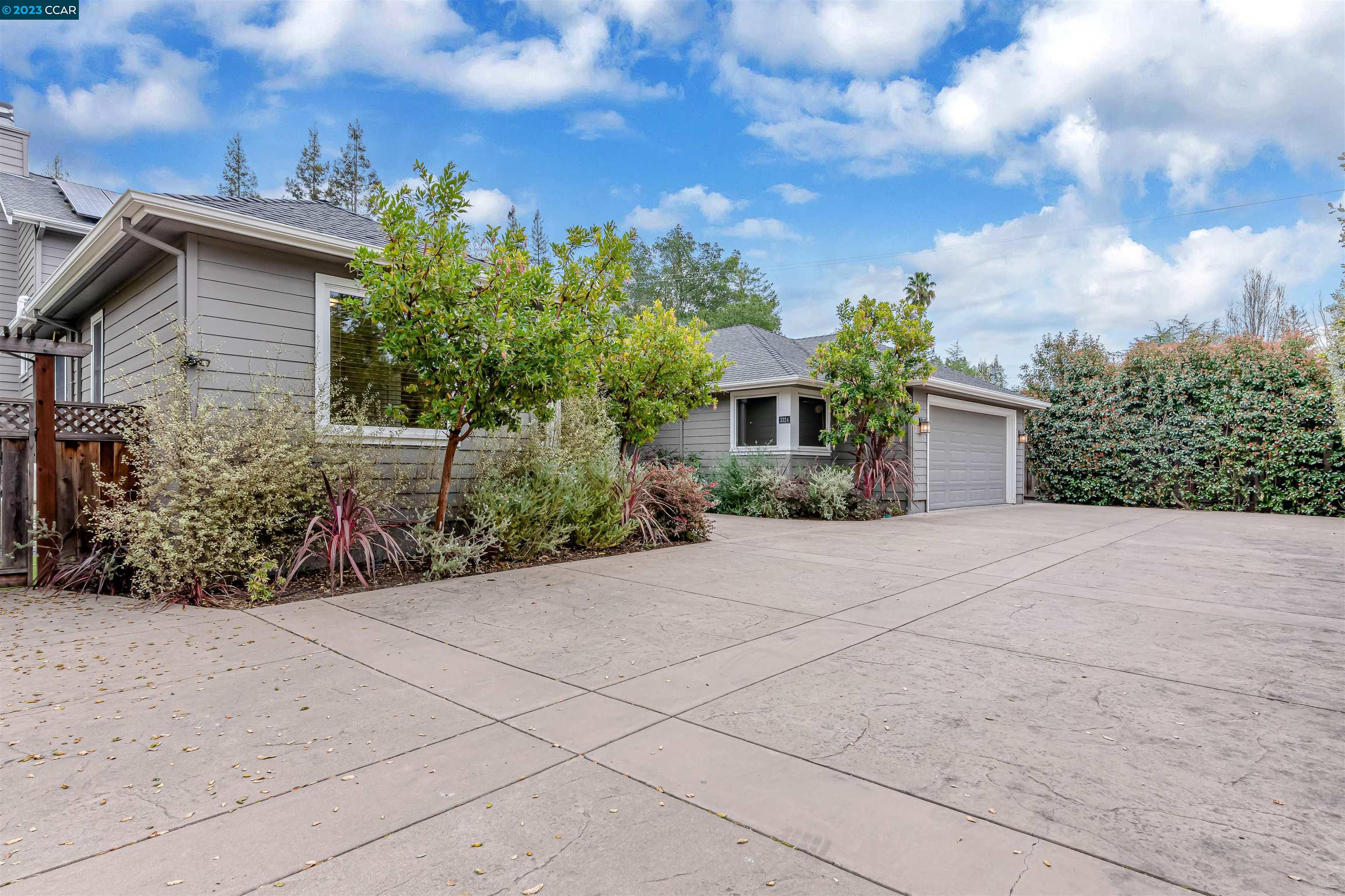 3324 Las Huertas Road Lafayette, CA 94549 - Photo 2 of 8 a front view of a house with a yard and garage