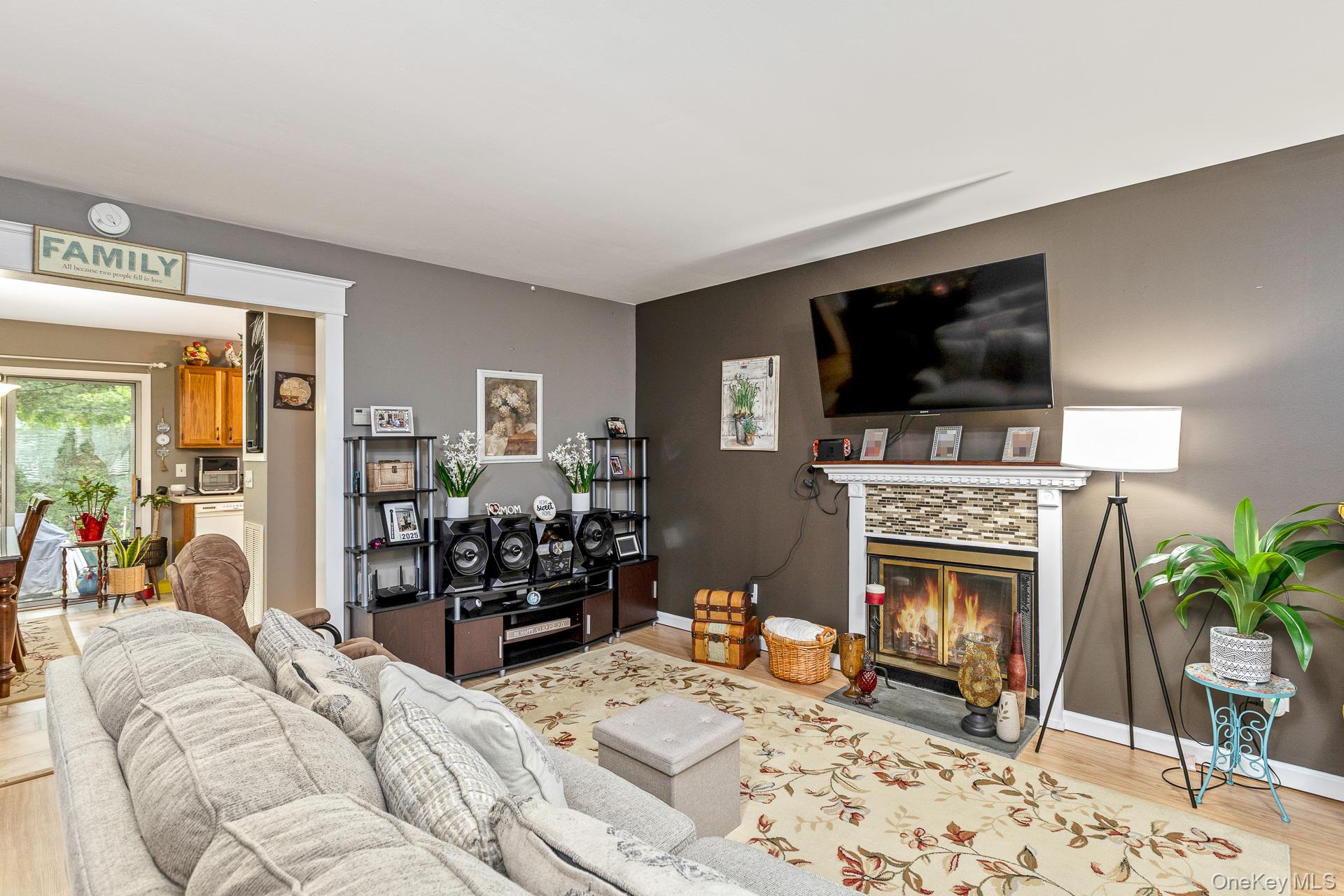 17 Stone Commons Yaphank, NY 11980 - Photo 8 of 31 Living area featuring a fireplace with a decorative tile surround and white mantel