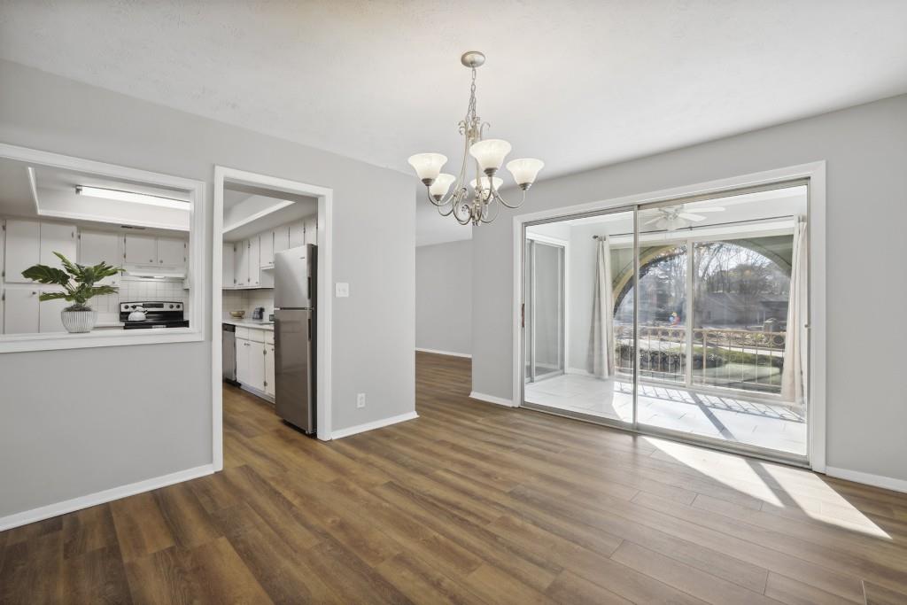 a view of a room with wooden floor