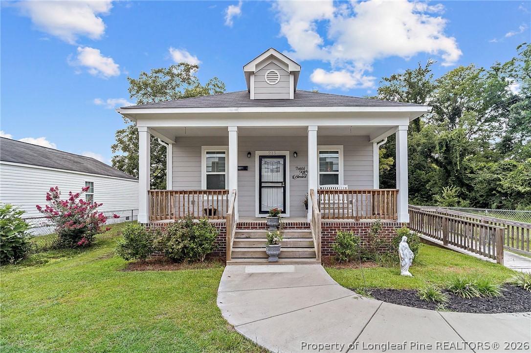215 Old Wilmington Road Fayetteville, NC 28301 - Photo 1 of 31 a front view of a house with garden