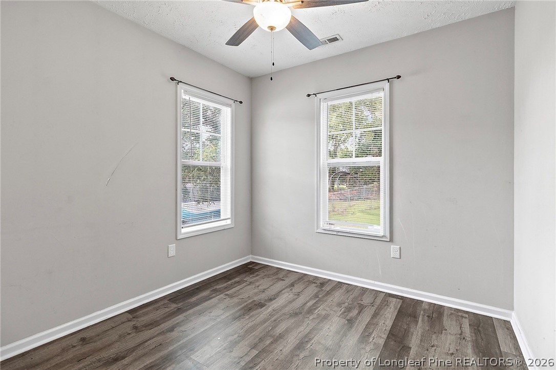 215 Old Wilmington Road Fayetteville, NC 28301 - Photo 12 of 31 an empty room with a window and wooden floor