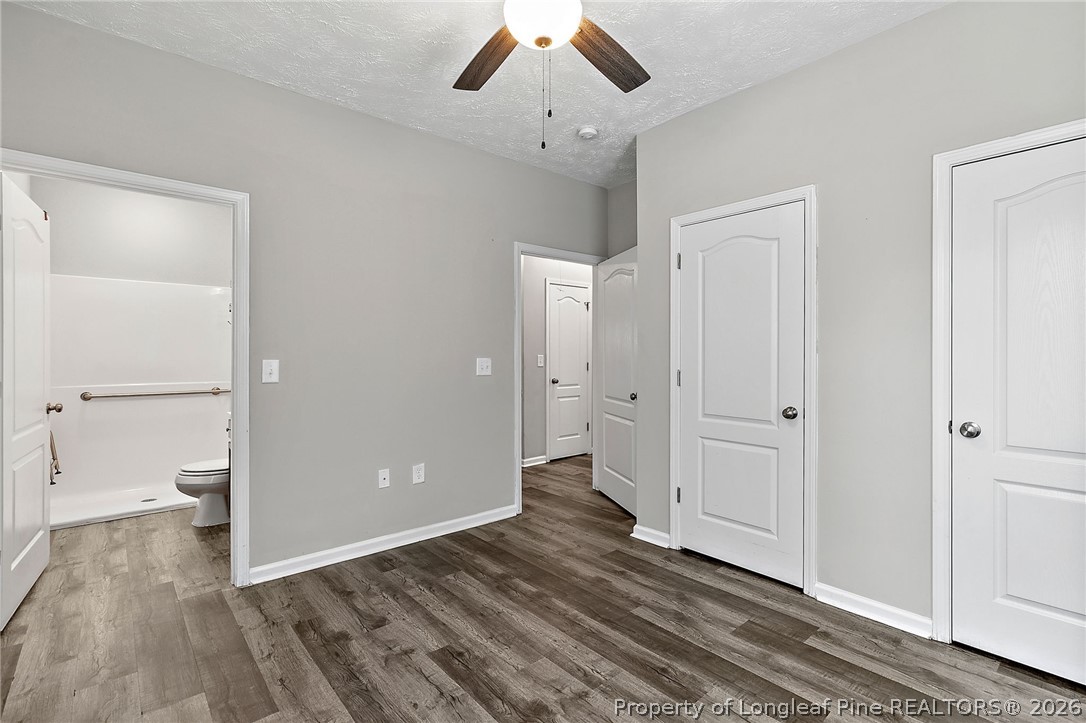 215 Old Wilmington Road Fayetteville, NC 28301 - Photo 15 of 31 a view of a room with wooden floor and a ceiling fan