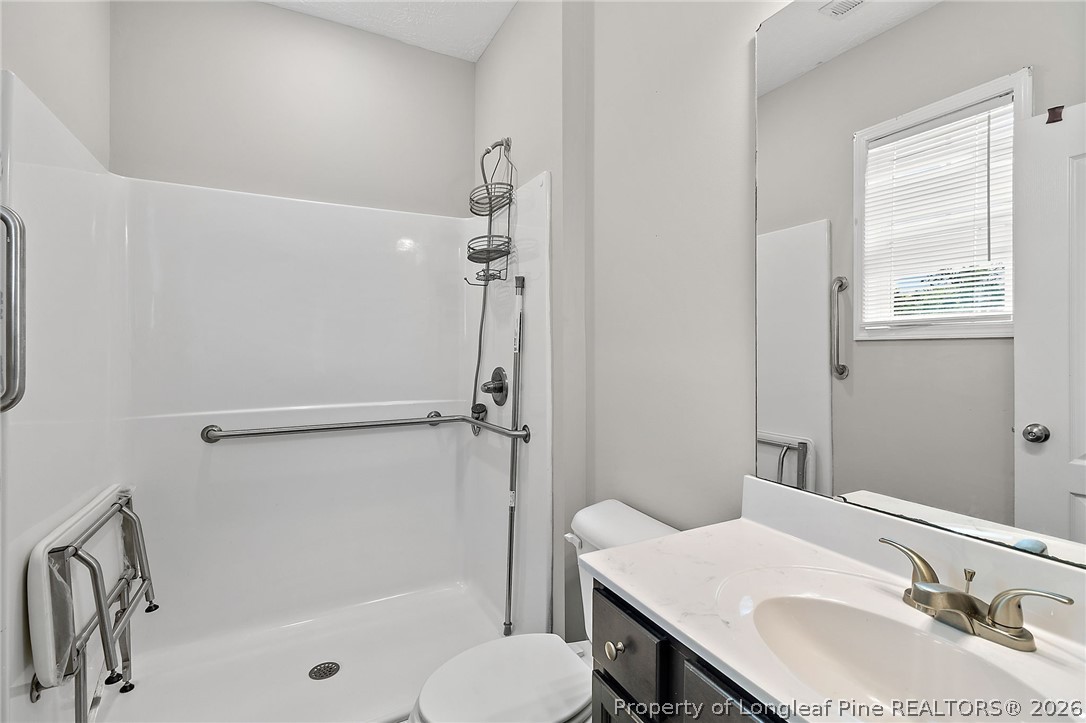 215 Old Wilmington Road Fayetteville, NC 28301 - Photo 16 of 31 a bathroom with a sink toilet and shower