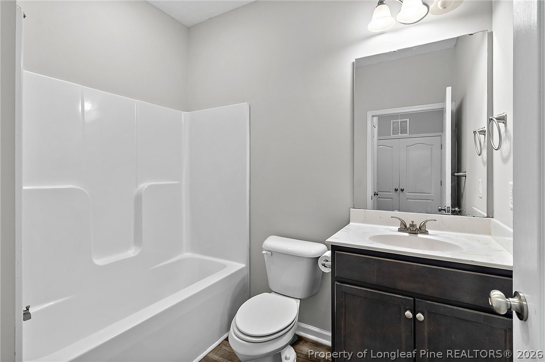 215 Old Wilmington Road Fayetteville, NC 28301 - Photo 20 of 31 a bathroom with a sink a toilet and shower