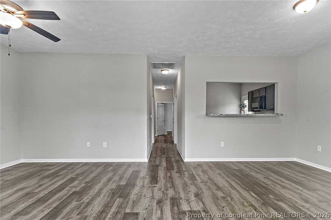 215 Old Wilmington Road Fayetteville, NC 28301 - Photo 3 of 31 a view of a livingroom with wooden floor and staircase