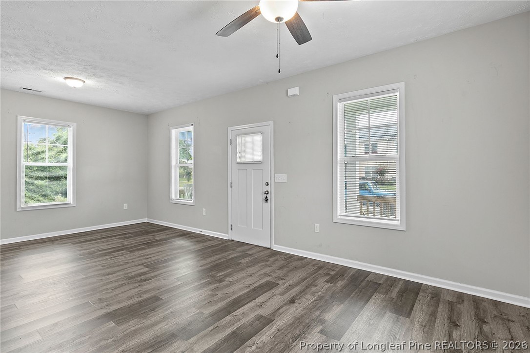 215 Old Wilmington Road Fayetteville, NC 28301 - Photo 5 of 31 a view of an empty room with wooden floor and a window