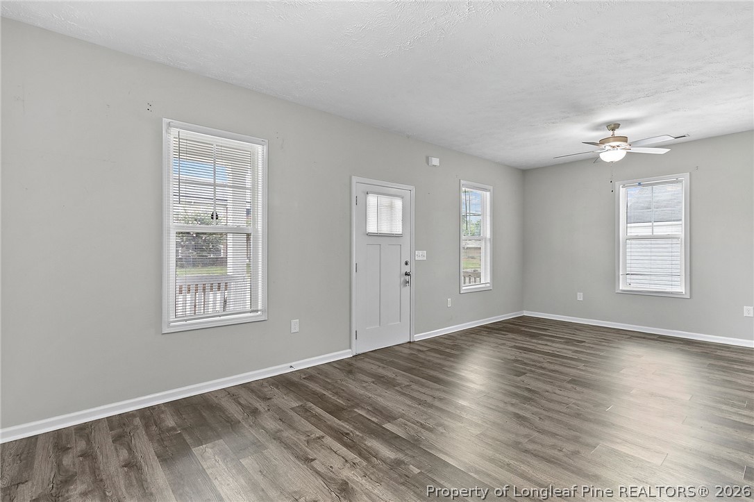 215 Old Wilmington Road Fayetteville, NC 28301 - Photo 7 of 31 a view of an empty room with a window and wooden floor