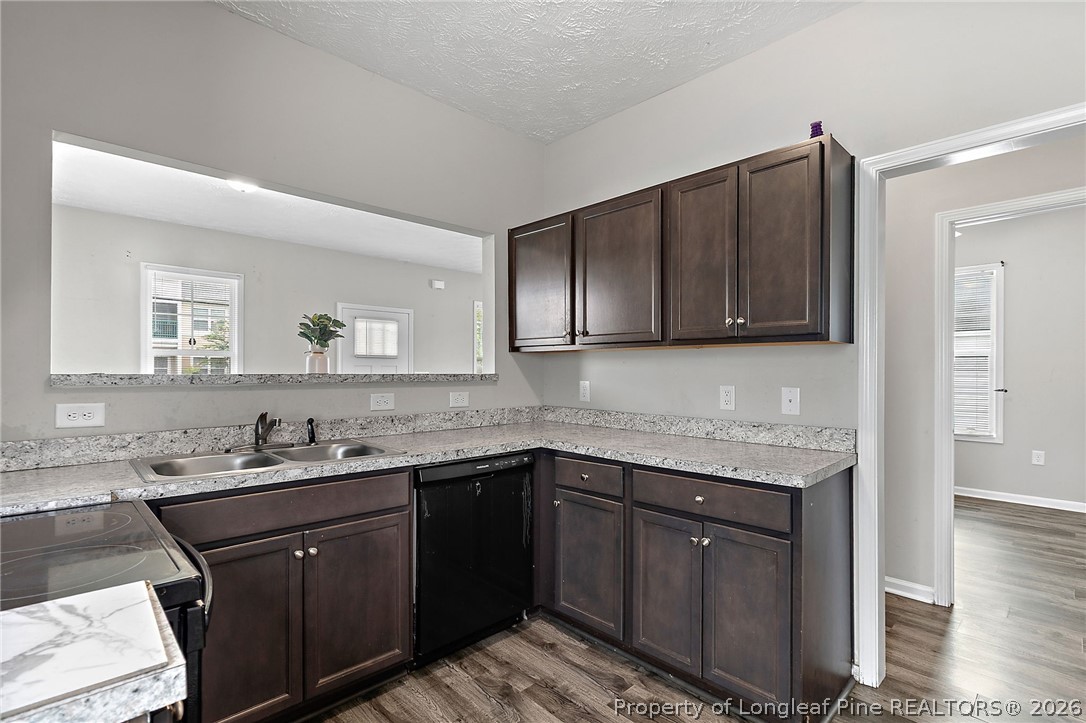 215 Old Wilmington Road Fayetteville, NC 28301 - Photo 10 of 31 a kitchen with stainless steel appliances granite countertop a sink stove and cabinets