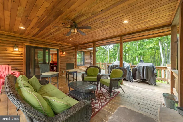a kitchen with stainless steel appliances kitchen island granite countertop a table and chairs in it