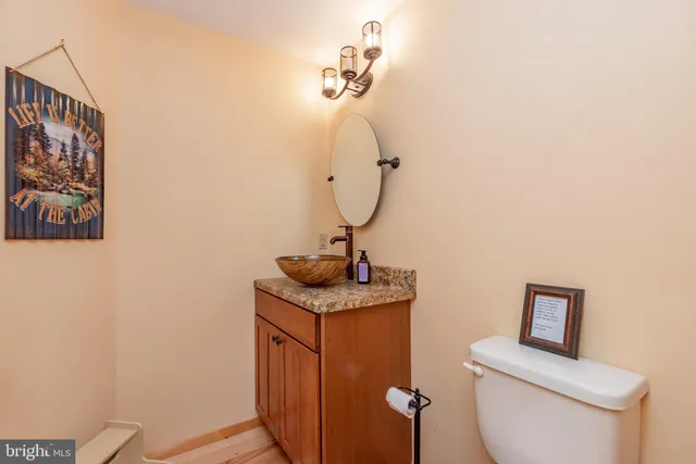 a bedroom with a large bed a flat tv screen and dresser