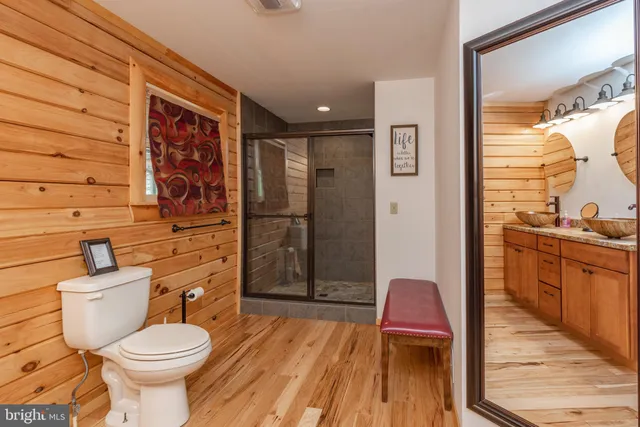 a bedroom with a large bed and a flat tv screen on dresser