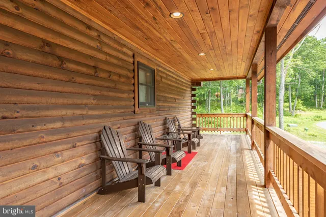 a kitchen with stainless steel appliances kitchen island granite countertop a table chairs and a refrigerator