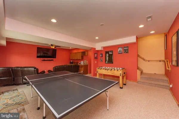 a room with gym equipment and a flat screen tv