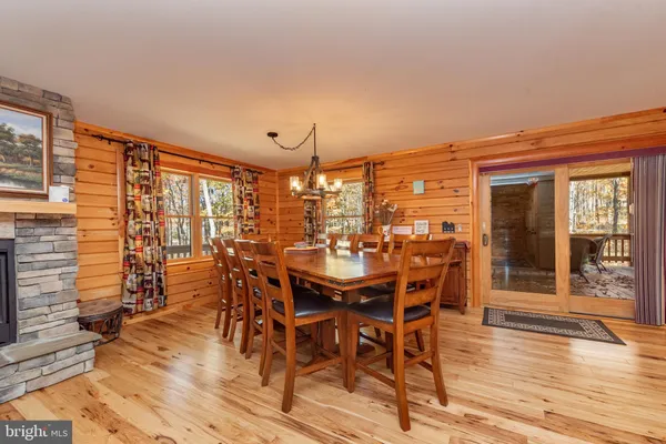 a dining room with furniture wooden floor and a chandelier