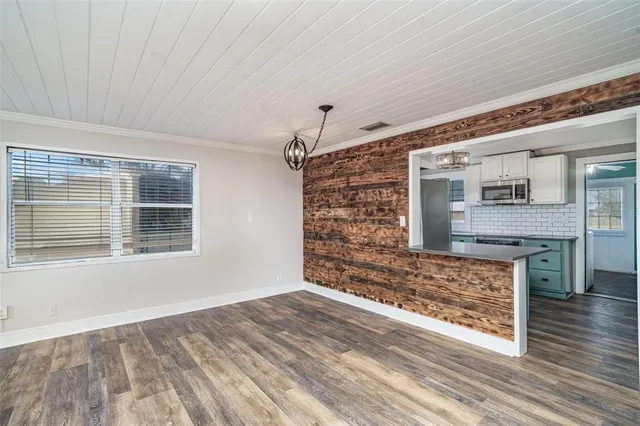 a view of an empty room with a fireplace and a window
