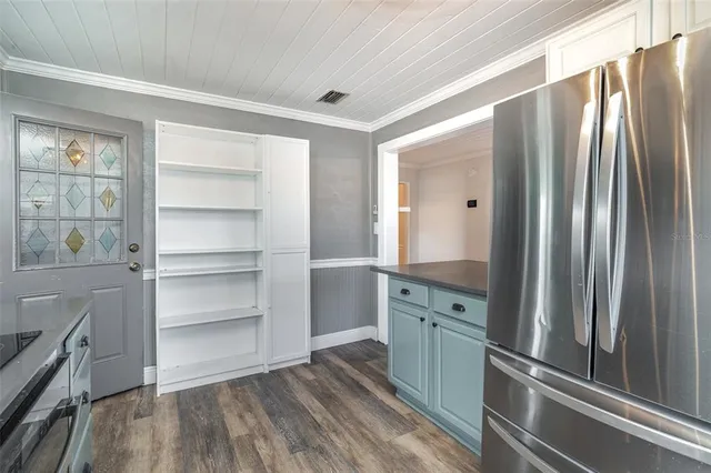 a view of a refrigerator in kitchen and wooden floor