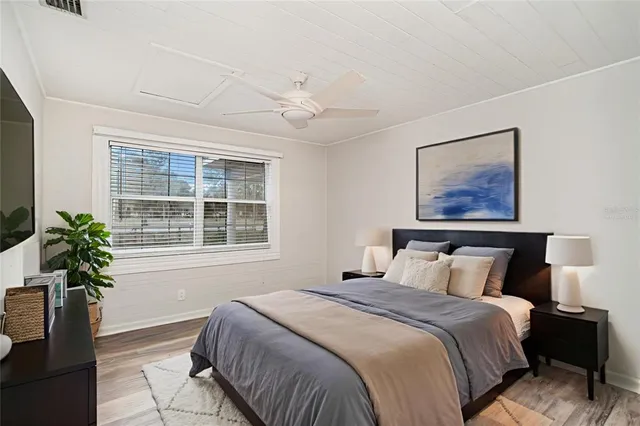 a bedroom with a large bed and a window