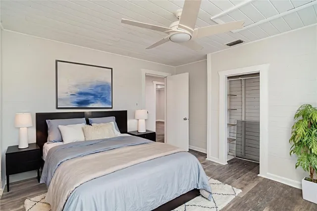 a bedroom with a large bed and a chandelier