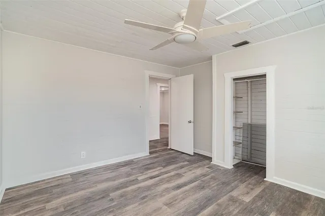 a view of an empty room with wooden floor