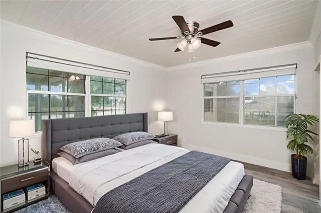 a bedroom with a bed and a window