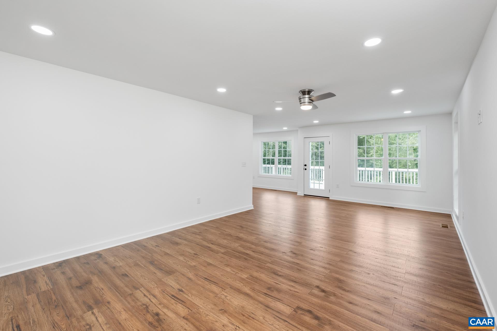 2211 Carpenters Mill Road Ruckersville, VA 22968 - Photo 10 of 25 an empty room with wooden floor and windows