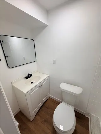 a white toilet sitting next to a white sink