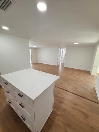 a room with a cabinets and chandelier