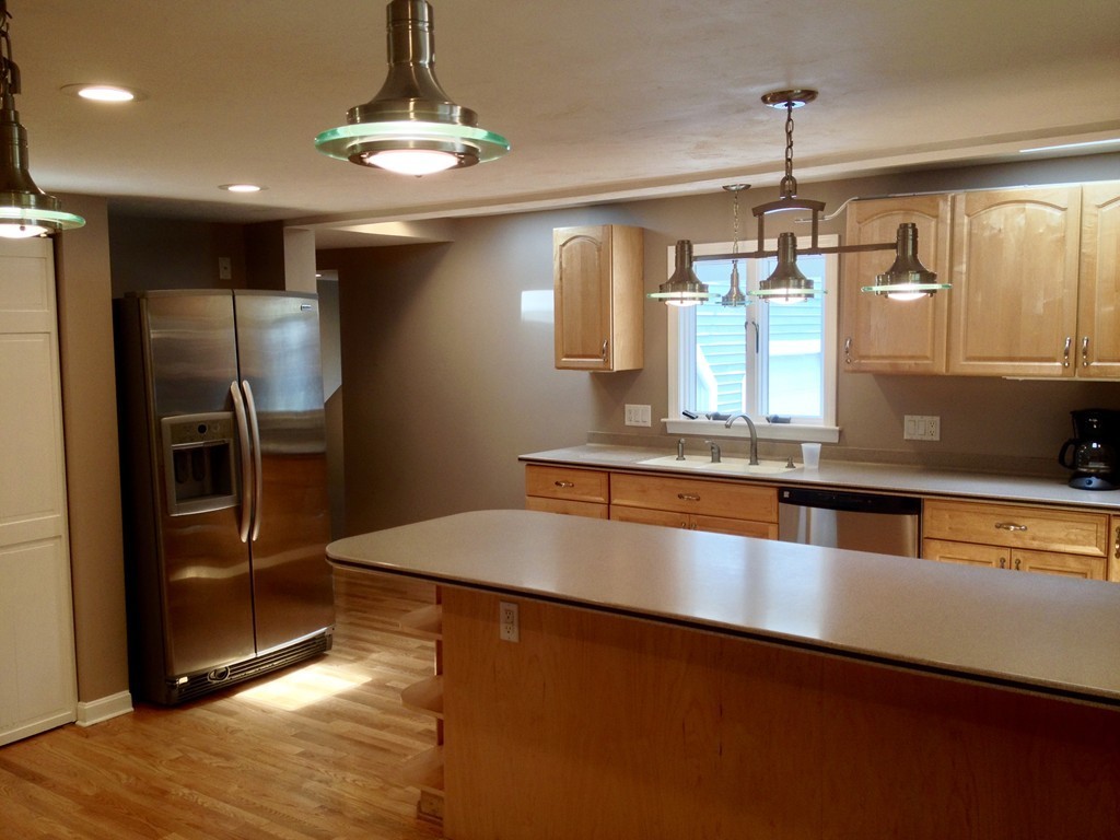96 Whalom Road Lunenburg, MA 01462 - Photo 4 of 20 a large kitchen with stainless steel appliances a large counter top a refrigerator and a sink