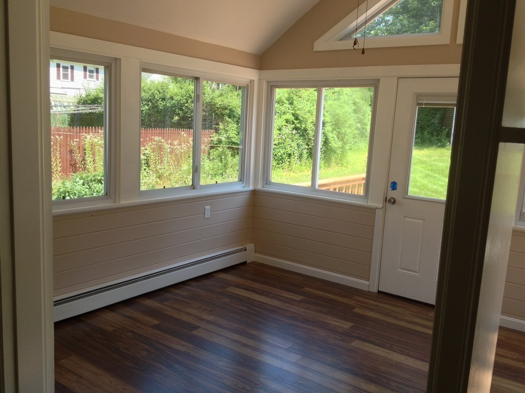 96 Whalom Road Lunenburg, MA 01462 - Photo 5 of 20 an empty room with wooden floor and windows