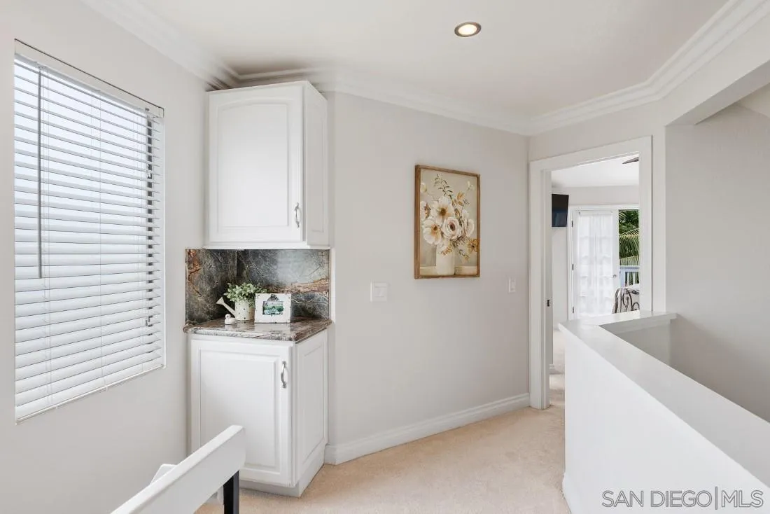 828 Bluewater Road Carlsbad, CA 92011 - Photo 23 of 36 a kitchen with a refrigerator and white cabinets