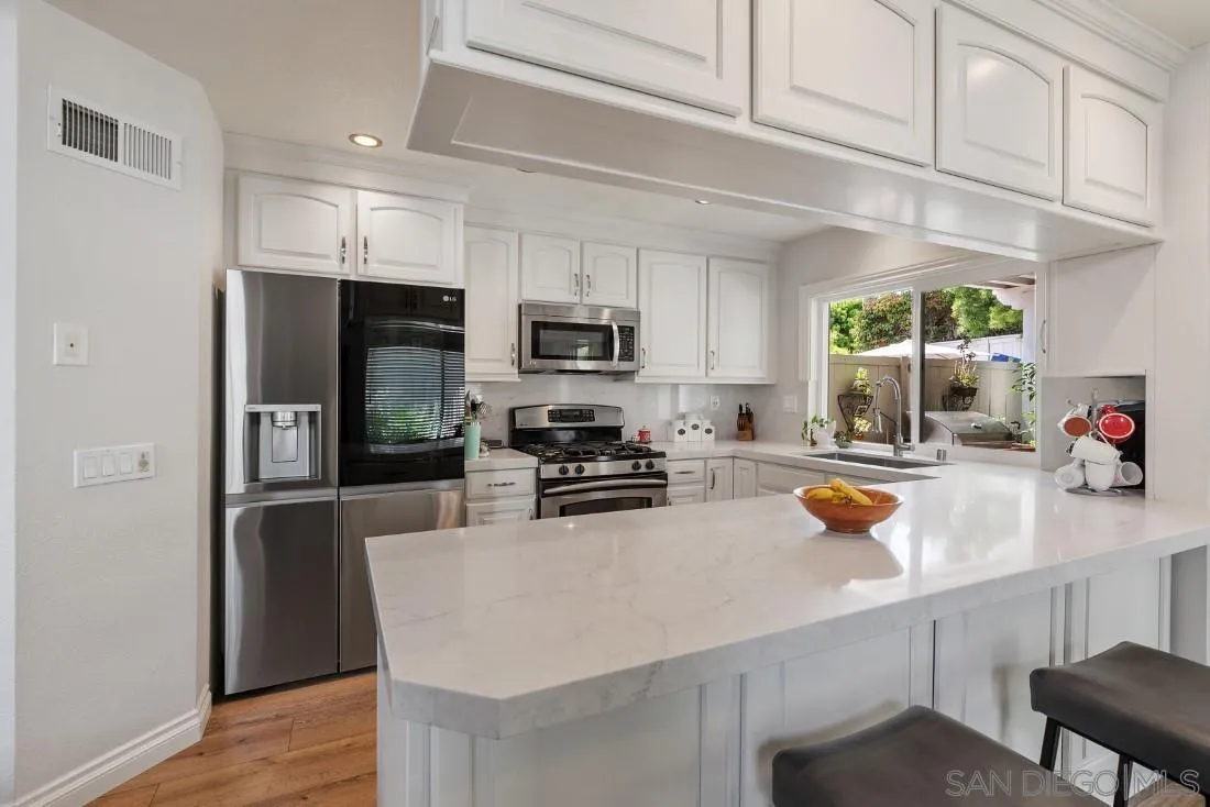 828 Bluewater Road Carlsbad, CA 92011 - Photo 10 of 36 a kitchen with a sink a stove and refrigerator