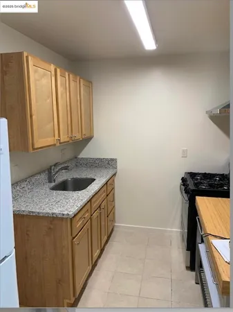 a stove top oven sitting inside of a kitchen