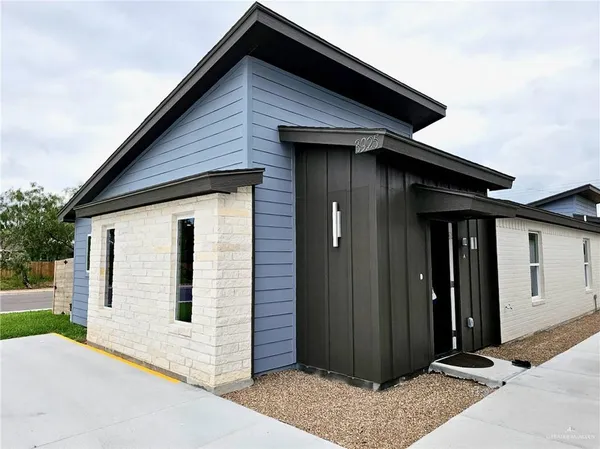 a kitchen with stainless steel appliances granite countertop a refrigerator a sink and a stove