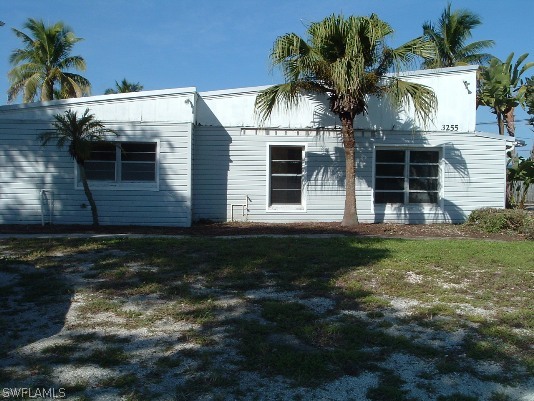 3255 Stringfellow Road St. James City, FL 33956 - Photo 1 of 16 a front view of a house with a yard