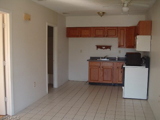 3255 Stringfellow Road St. James City, FL 33956 - Photo 14 of 16 a kitchen with a sink a stove and cabinets