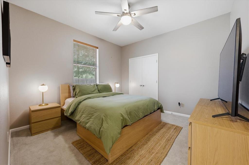 3413 Westfork Ranch Road Fort Worth, TX 76262 - Photo 21 of 35 Carpeted room featuring a ceiling fan with integrated lighting, a window with blinds, and white bi-fold closet doors