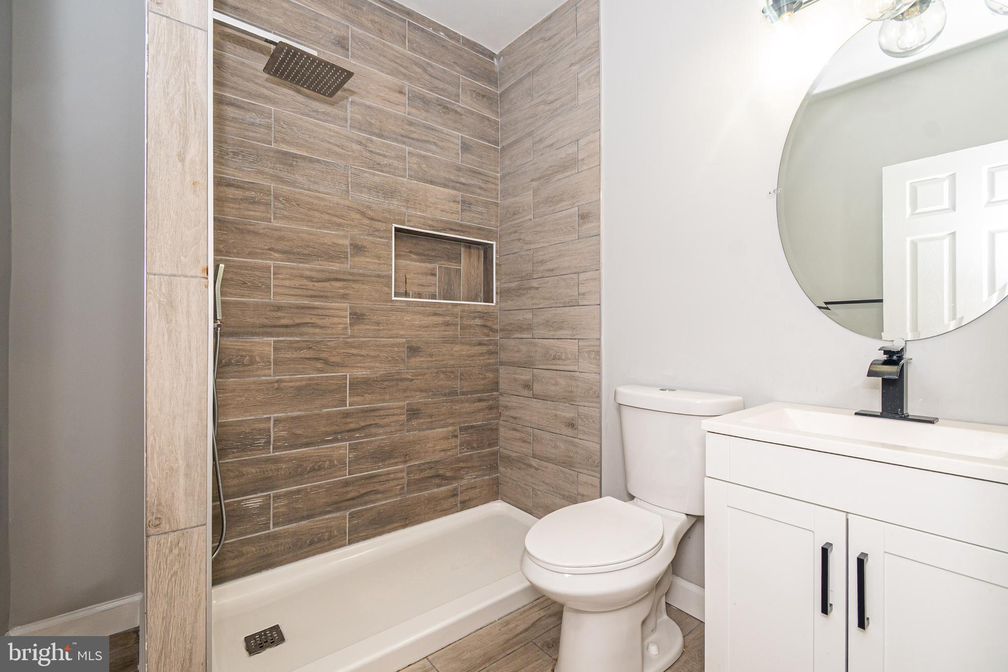 3103 East Monument Street Baltimore, MD 21205 - Photo 11 of 20 a bathroom with a sink toilet and shower