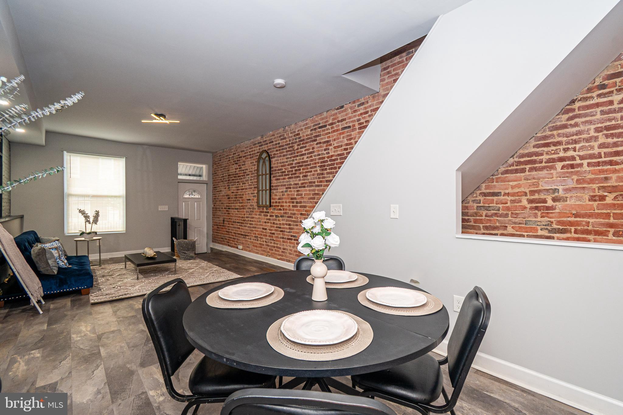 3103 East Monument Street Baltimore, MD 21205 - Photo 5 of 20 a view of a dining room with furniture and window
