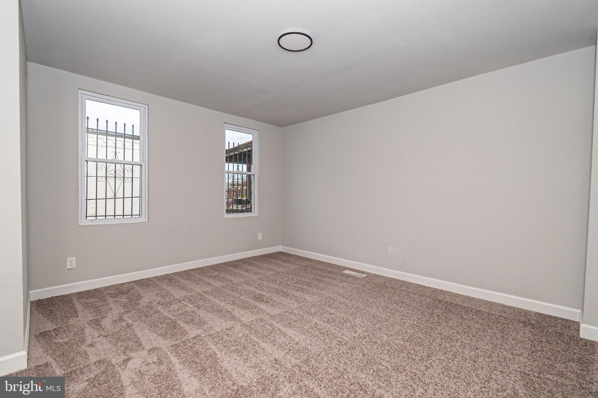 3103 East Monument Street Baltimore, MD 21205 - Photo 9 of 20 an empty room with windows