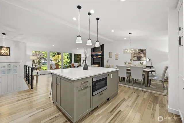 a kitchen with stainless steel appliances granite countertop a stove and a wooden floors