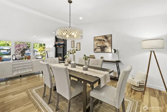 a view of a dining room with furniture wooden floor and chandelier