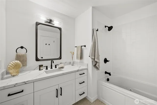 a bathroom with a sink double vanity and tub
