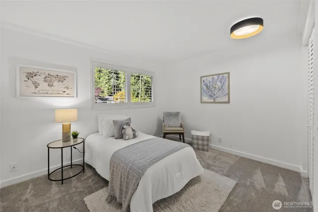 a bedroom with a bed and a painting on the wall