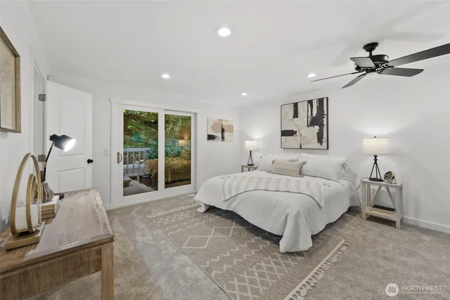 a spacious bedroom with a bed and a couch