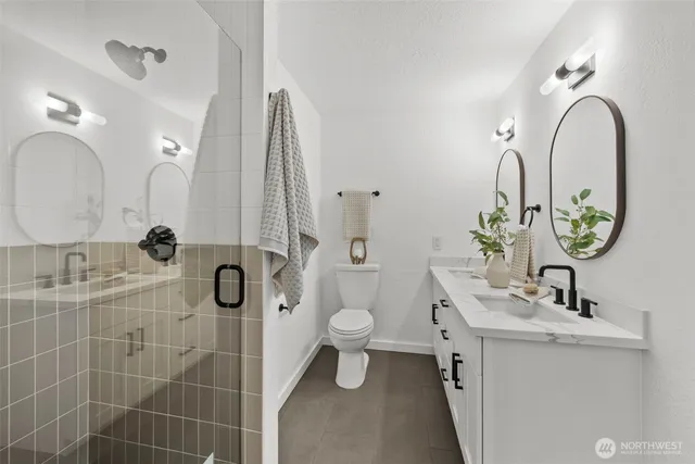 a bathroom with a toilet sink and shower