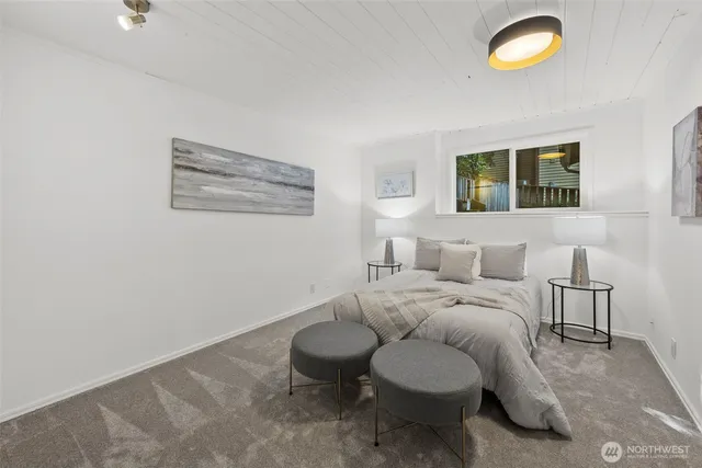 a bedroom with a bed and glass window