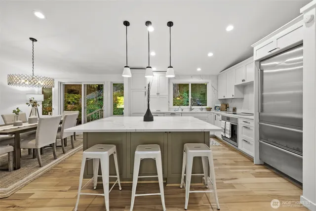 a kitchen with a table chairs refrigerator and cabinets