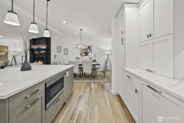 a large kitchen with kitchen island a large counter space a sink appliances and cabinets