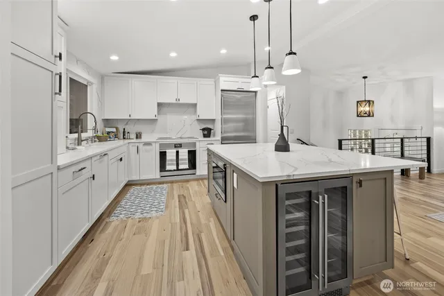 a kitchen with sink stove and refrigerator