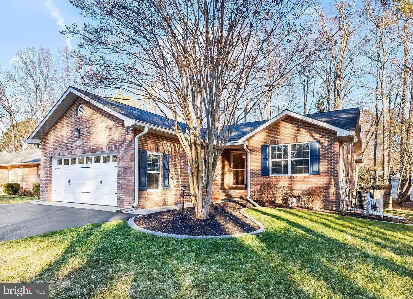 Charming brick home with lush landscaping.